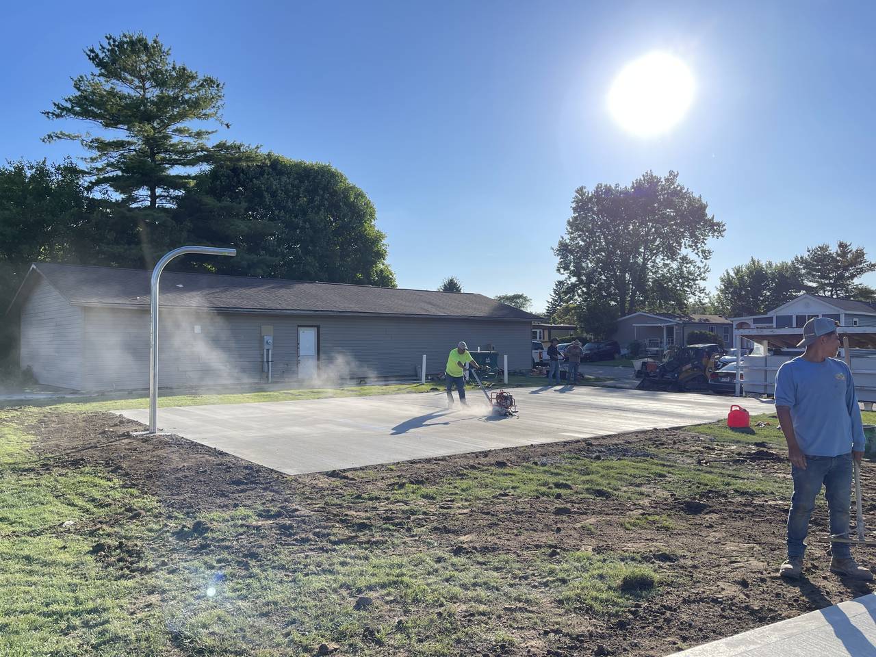 Concrete basketball slab with embedded hoop post at a mobile home community, Plain City, Ohio
