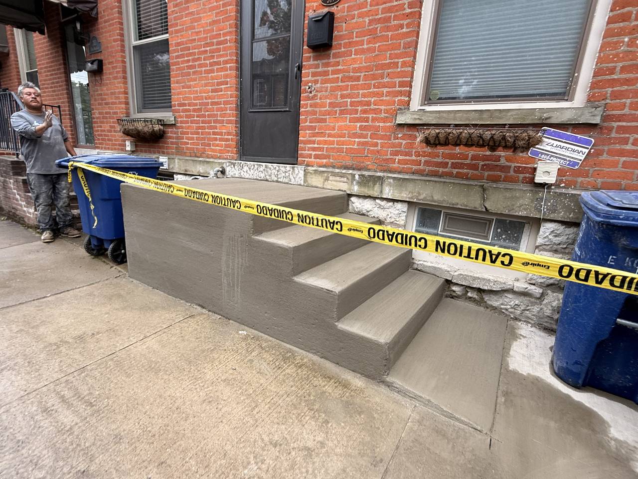 New concrete entry steps at a brick rowhouse