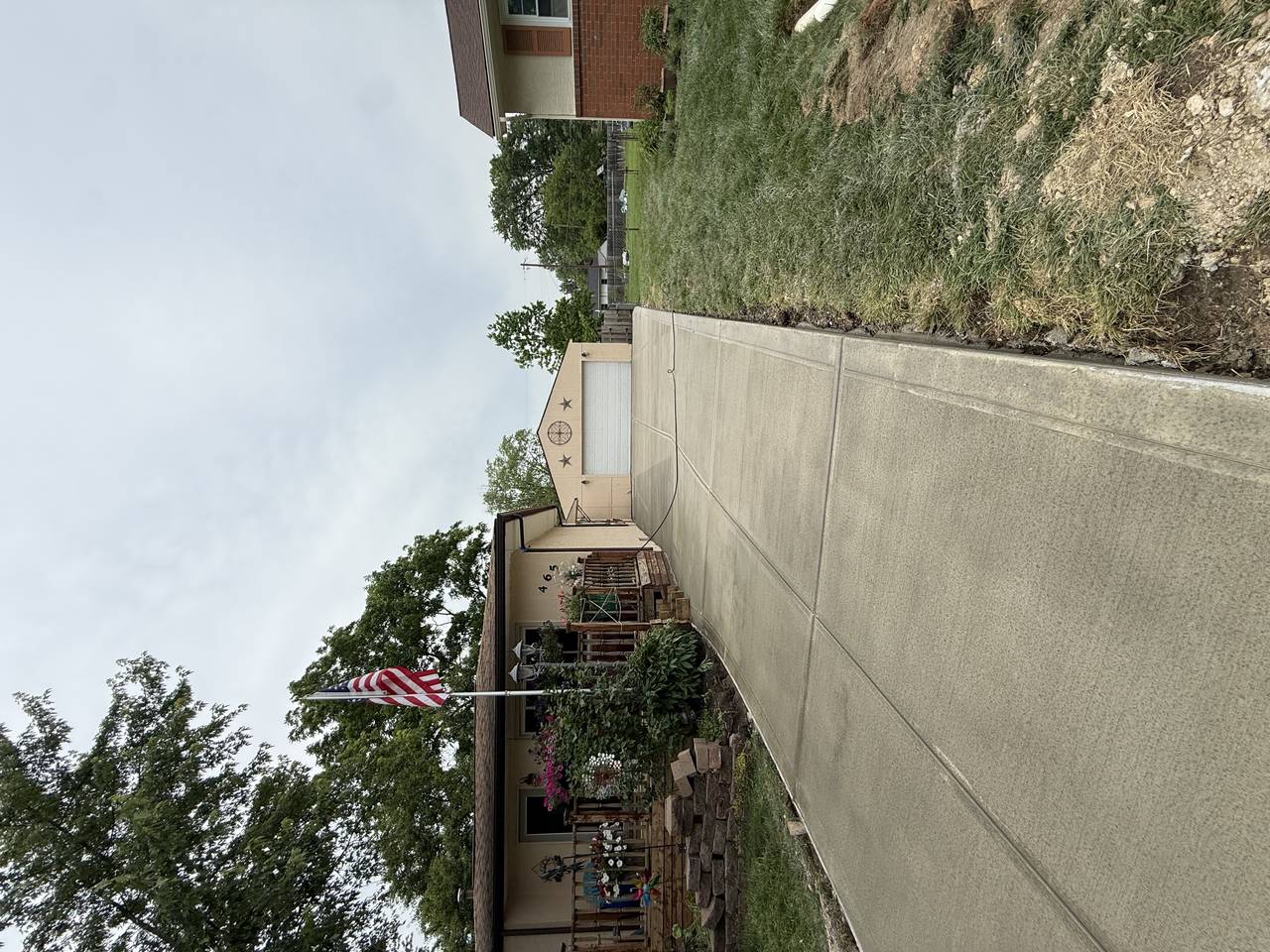 Broom-finish concrete driveway leading to a two-car garage