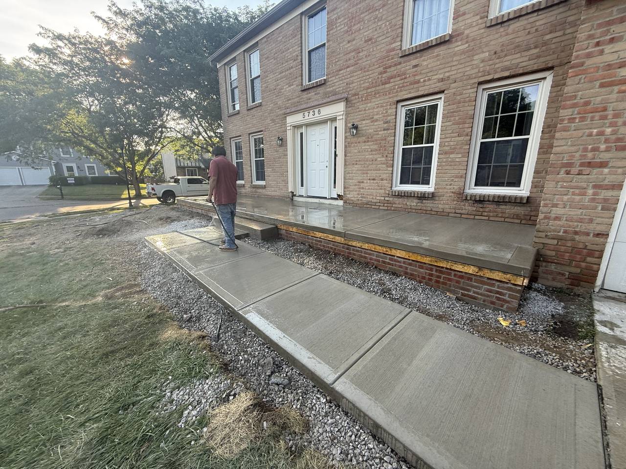 Front entry porch, steps, and walkway with a sealed concrete finish