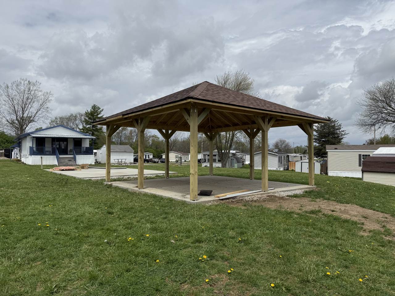 Open wood pavilion on a poured concrete pad