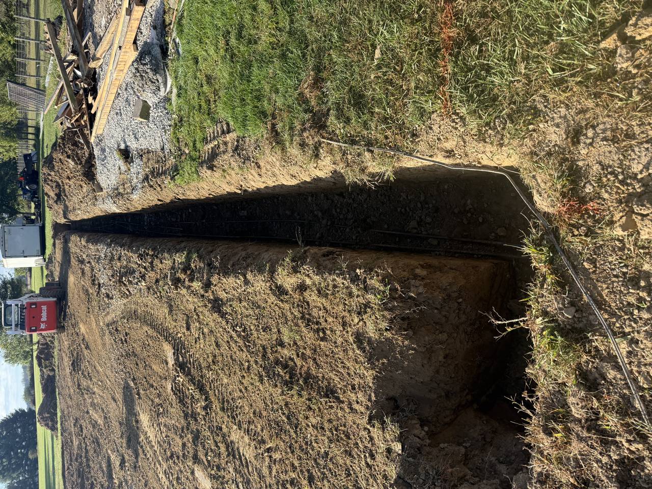 Trench and continuous footing preparation for a pole barn slab