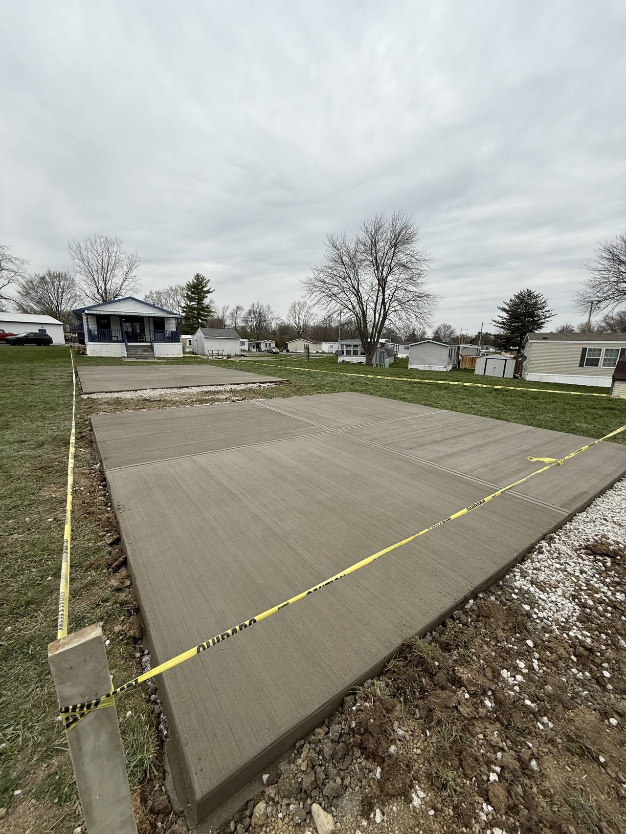 Two concrete shed pads at a mobile home community